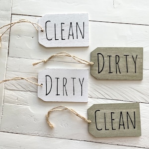 May include: Four wooden tags with twine, two white and two gray. The white tags say "CLEAN" and "DIRTY" and the gray tags say "DIRTY" and "CLEAN".