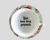 You&#39;ve been Poisoned Tea Cup & Bye Saucer, Green and Red Rose Floral Pattern