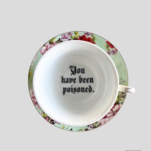 You've been Poisoned Tea Cup & Bye Saucer, Green and Red Rose Floral Pattern