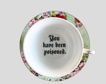 You've been Poisoned Tea Cup & Bye Saucer, Green and Red Rose Floral Pattern