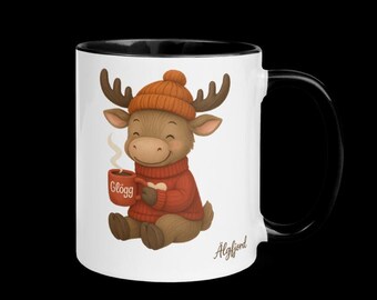 May include: A white ceramic mug with a black interior and handle. The mug features a cartoon moose wearing an orange knit cap and red sweater, holding a mug of "Glögg." The mug has the word "Älgfjord" printed on it.