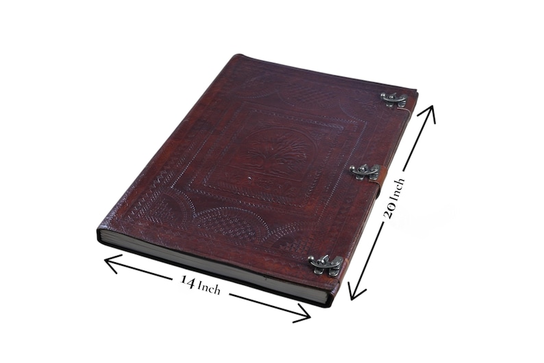 May include: A dark brown leather journal with embossed designs and metal clasps. The journal measures 14 inches wide and 20 inches long. The cover features a central embossed design and decorative patterns.