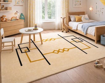 May include: A rectangular area rug featuring a light beige base with a geometric pattern consisting of bold black lines and mustard yellow outlines of squares and diamonds. The rug is positioned on a wooden floor in a room with furniture.