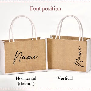 May include: Two jute tote bags with white trim and handles. The bags have the word "Name" printed in a cursive font. One bag has the text horizontally, and the other vertically. The bags are on a white background.