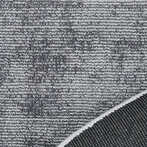 May include: Close-up of a gray rug with a textured surface. The rug has a pattern of darker gray spots and a white border. The rug's texture is visible, with a mix of light and dark gray fibers.