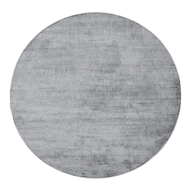May include: A round, light gray rug with a textured surface. The rug has a solid color and a simple design, suitable for various interior styles. The rug is a neutral color that can complement different decor.