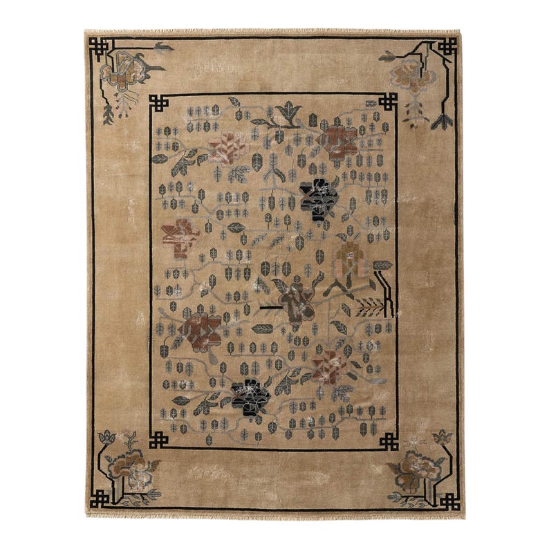 May include: A rectangular beige rug with a floral pattern. The rug features a central design of flowers and leaves in shades of brown, gray, and black, framed by a black border. The corners have decorative floral motifs.