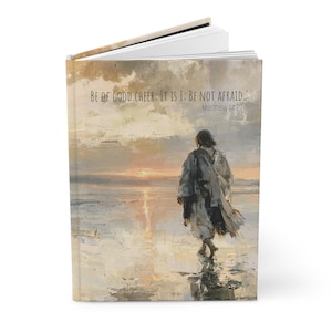 May include: A hardback book featuring a painting of a figure walking on water at sunset. The text "BE OF GOOD CHEER; IT IS I; BE NOT AFRAID." and "Matthew 14:27" are printed in the upper portion of the cover against a cloudy, golden sky.