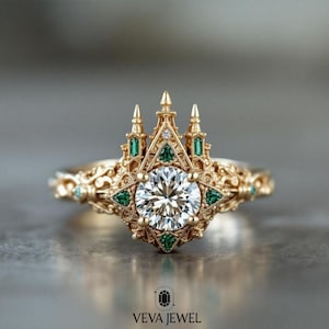 May include: A gold ring with a castle-like design. The ring features a large, round, clear gemstone at the center, surrounded by smaller green gemstones and intricate gold detailing. The ring has a unique, ornate style.