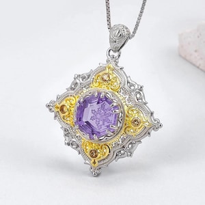 May include: A silver pendant necklace with a large, faceted purple gemstone at the center. The pendant has a gold filigree design around the gemstone and is shaped like a diamond. Small, round, amber-colored stones are set around the edges.