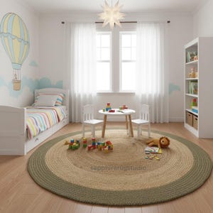 May include: A round jute rug with a green border and a natural center sits in a child's room. The room features a bed, small table, chairs, and a bookshelf. A hot air balloon mural decorates the wall.