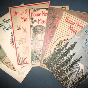 May include: A collection of vintage "Home Needlework Magazine" covers. The covers feature various illustrations, including dragonflies, a peacock, floral designs, and a winter landscape. The magazines are arranged in a fan shape, showcasing their aged paper and artistic covers.