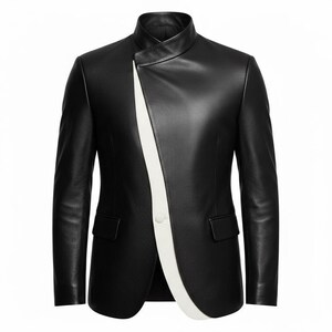 May include: A black leather jacket with a unique asymmetrical design. The jacket features a mandarin collar and a white stripe that runs diagonally across the front. It has two pockets and a single button closure.