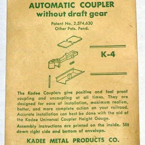 May include: Tan paper packaging for Kadee HO automatic couplers without draft gear. Green text and diagrams detail the product, including patent information and the Kadee Metal Products Co. address.