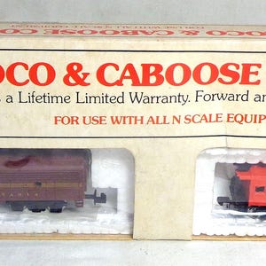 May include: A Bachmann Loco & Caboose Combo set in its original packaging. The box features a maroon locomotive and a red caboose. The text on the box reads "Locomotive has a Lifetime Limited Warranty. Forward and reverse. Smooth gear drive."