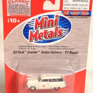 May include: A white '53 Ford Courier Sedan Delivery toy car, part of the Mini Metals collection, is displayed in a clear plastic case. The packaging is red and white, with the Classic Metal Works logo and the text "TV Repair."