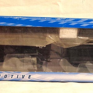 May include: A black model train locomotive in a blue box. The box has the brand name "Bachmann" and the words "DCC-Equipped Locomotive" printed on it. The train is labeled "New York Central".