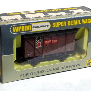 May include: A brown box with a yellow border and the text "Wrenn Railways Super Detail Wagons" on the front. The box contains a model train car with the text "Robertson's" on the side. The box is for OO/HO gauge railways.