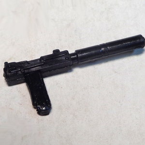 May include: A black plastic toy gun with a long barrel and a pistol grip.