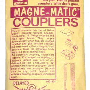 May include: A package for "Magne-Matic Couplers" model 802, featuring two pairs of Delrin plastic couplers with draft gear. The package is tan with magenta text and illustrations. The text includes "Delayed Magnetic Uncoupling" and "Kadee Quality products co."