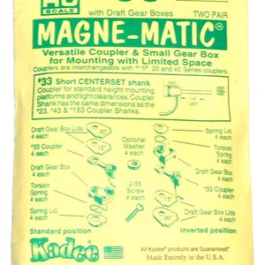 May include: A yellow and green package for HO scale model train couplers. The package features the text "MAGNE-MATIC" and diagrams of the coupler parts. The package also includes the text "#33" and "TWO PAIR".