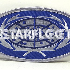 May include: A blue and silver embroidered patch with the text "Starfleet" in white.