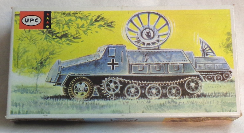 May include: A plastic model kit of a German military vehicle with a radar dish on top. The vehicle is painted in a blue-grey color and has a white cross on the side. The box art shows the vehicle in a grassy field.