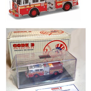 May include: A 1/64 scale die-cast model of a New York City Fire Department Seagrave Pumper E-68, in a clear display case with a certificate of authenticity. The model is part of the Code 3 Collectibles series, "Preserve the Honor."