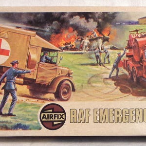 May include: A model kit box for a RAF Emergency Set 00. The box features a red fire truck and a white ambulance with a red cross. The box is labeled "RAF EMERGENCY SET 00" and "AIRFIX".