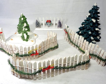 Miniatuur kerstaccessoires voor je Department 56-baan tijdens de feestdagen. Inclusief gegoten en porseleinen bomen en buigbare hekken.