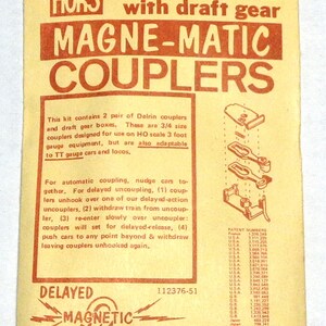 May include: A vintage Kaddee HO scale model train coupler kit. The package is yellow with red text, featuring "MAGNE-MATIC COUPLERS" and instructions. Includes two pairs of couplers and draft gear boxes.