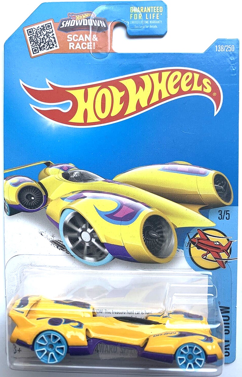 May include: Yellow Hot Wheels Treasure Hunt car with purple flames and blue wheels. The car is a futuristic design with two jet engines on the back. The car is on a blue background with the words "Hot Wheels" and "Showdown" on the top. The car is numbered 138/250 and 3/5.