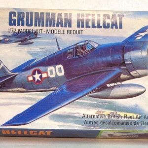 May include: A blue and white 1/72 scale model kit of a Grumman Hellcat fighter plane. The box art features a close-up of the plane in flight over the ocean. The box includes alternative British Fleet Air Arm decals.