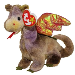 May include: A soft toy dragon with a red tongue, iridescent wings, and a heart-shaped tag. The dragon is mainly brown with purple accents and green feet. The wings have a shimmering, multi-coloured effect.