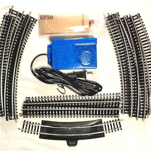 HO Scale Complete train track oval with Nickel-Silver Track and Lifelike power transformer - All you need are the trains! This is pre-owned.
