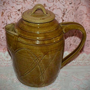 May include: A rustic wooden sign with the text "Welcome to our home" in white lettering. The sign features a distressed finish and a simple, inviting design, perfect for entryway decor.