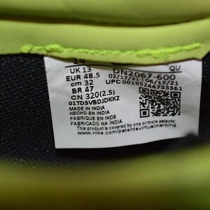 May include: Close-up of a product label with the text "UK 13, EUR 48.5, cm 32, BR 47, CN 320(2.5)". The label also includes a QR code and the text "MADE IN INDIA". The background is black and neon green.