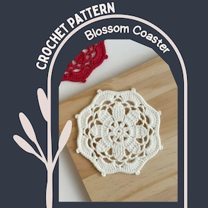 May include: A white crochet coaster with a floral design, resting on a wooden surface. The coaster is surrounded by the text "CROCHET PATTERN Blossom Coaster". A red crochet coaster is partially visible in the background.