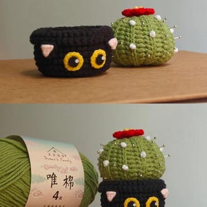 May include: Crocheted cactus and cat-themed pincushions. The cactus is green with a red flower and white dots, and the cat pincushion is black with yellow eyes and pink ears. A skein of green yarn is also in the image.
