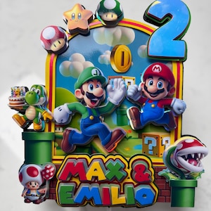 May include: A colorful birthday cake topper featuring Mario and Luigi characters, a large blue number 2, and the names "Max & Emilio". The design includes a coin, a star, mushrooms, and a Piranha Plant.