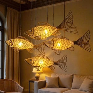 May include: Four fish-shaped pendant lights made of woven material hang from the ceiling. The lights are illuminated, casting a warm glow. The fish have detailed fins and tails, adding a unique decorative element to the room.