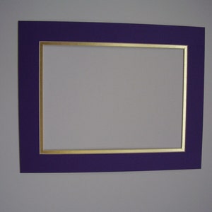 May include: A purple picture frame with a gold inner border. The frame is empty.