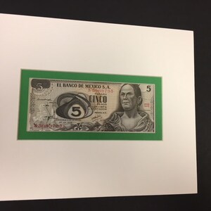 May include: A green framed banknote from Mexico with a portrait of a man and the number "5" printed in red. The text "EL BANCO DE MEXICO S.A." is printed in black at the top of the banknote.