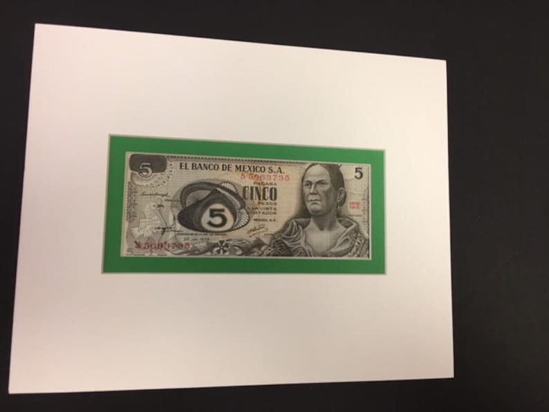 May include: A green framed banknote from Mexico with a portrait of a man and the number "5" printed in red. The text "EL BANCO DE MEXICO S.A." is printed in black at the top of the banknote.
