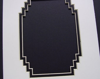 May include: White mat with a black and white geometric border. The mat has a rectangular opening in the center.