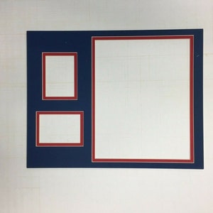 May include: A navy blue picture frame with a red border. The frame has three openings, one large and two smaller ones. The openings are all empty.