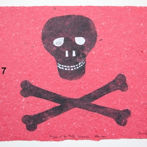 May include: A red paper print of a black skull and crossbones with the text "no. 7" and "Burgess of the Pirate Guild 1993-1990" in black ink.