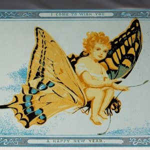May include: A vintage greeting card with a blue border and a whimsical illustration of a fairy riding a butterfly. The text on the card reads "I come to wish you a happy new year."