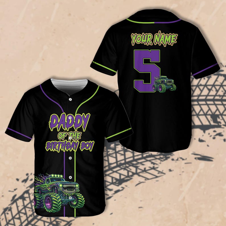 May include: Black baseball jersey with green and purple accents. The front features the text "DADDY OF THE BIRTHDAY BOY" and a monster truck graphic. The back has the text "YOUR NAME" above a large number 5 and a monster truck.