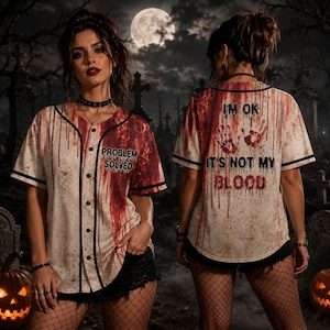May include: A short-sleeved button-down baseball jersey featuring a cream base with a red blood splatter pattern. The front displays the text "PROBLEM SOLVED" and the back features two red handprints with the text "I'M OK IT'S NOT MY BLOOD".